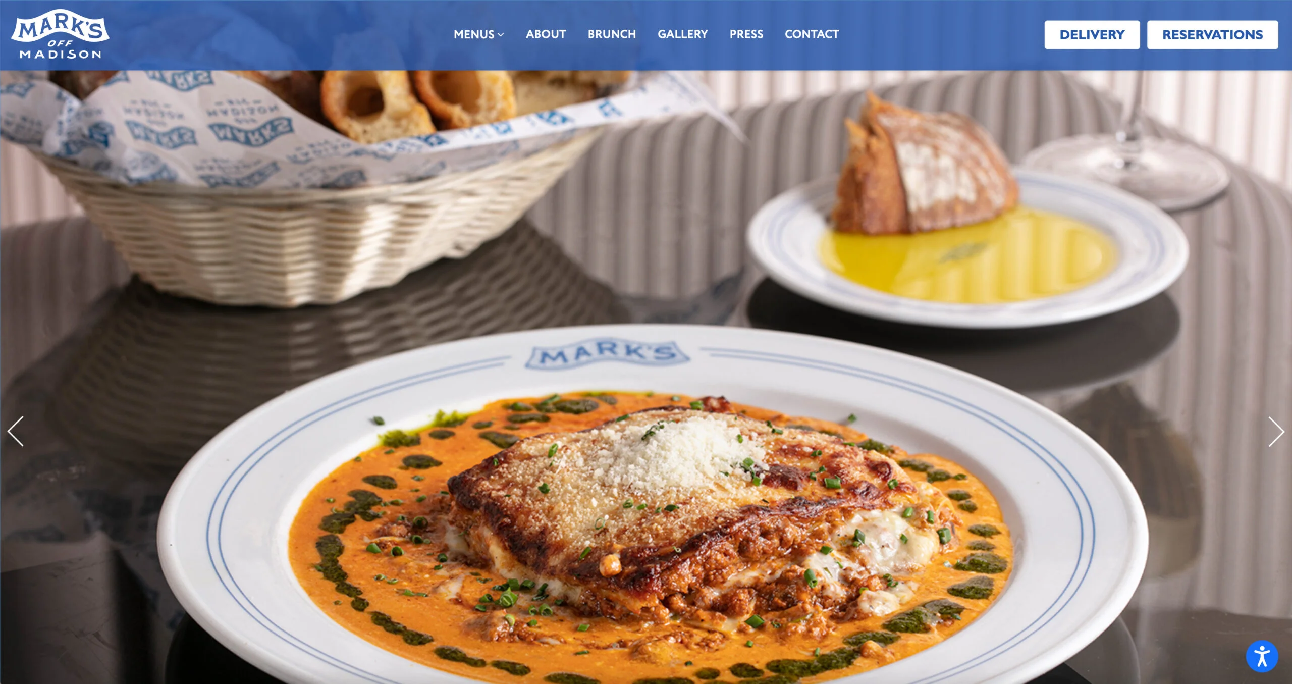 Mark's Off Madison website design screenshot featuring lasagna on a plate with some bread and olive oil to the side